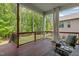 Expansive outdoor deck featuring wooded views, dark wood railings, and comfortable seating at 1620 Hasentree Villa Ln, Wake Forest, NC 27587