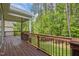 Spacious deck with wood flooring and dark railings overlooking a vibrant wooded backyard at 1620 Hasentree Villa Ln, Wake Forest, NC 27587