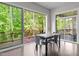 Bright dining room with hardwood floors, table, and sliding glass doors to the outdoor deck at 1620 Hasentree Villa Ln, Wake Forest, NC 27587