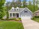 Beautiful two-story home with a well-maintained lawn, a two-car garage, and a welcoming front porch at 1620 Hasentree Villa Ln, Wake Forest, NC 27587