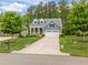 Charming blue home with a well-kept lawn, two-car garage, and inviting front yard at 1620 Hasentree Villa Ln, Wake Forest, NC 27587