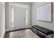 Bright foyer features a white front door with sidelights, a bench, and a textured art piece at 1620 Hasentree Villa Ln, Wake Forest, NC 27587