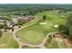 Picturesque aerial view of a well-manicured golf course featuring manicured greens and sand bunkers at 1620 Hasentree Villa Ln, Wake Forest, NC 27587
