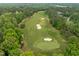 Scenic aerial view of a pristine golf course featuring lush fairways, sand traps, and mature trees at 1620 Hasentree Villa Ln, Wake Forest, NC 27587