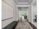 Elegant hallway features hardwood floors, neutral walls, and a bench providing a welcoming atmosphere at 1620 Hasentree Villa Ln, Wake Forest, NC 27587
