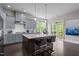 Modern kitchen with a large island, pendant lighting, stainless steel appliances, and gray cabinetry at 1620 Hasentree Villa Ln, Wake Forest, NC 27587