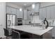 Bright kitchen with a large island, quartz countertops, stainless steel appliances, and modern gray cabinets at 1620 Hasentree Villa Ln, Wake Forest, NC 27587