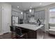 Open kitchen with a large center island, stainless steel appliances, ample storage, and modern gray cabinetry at 1620 Hasentree Villa Ln, Wake Forest, NC 27587