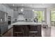Well-equipped kitchen featuring a large island with seating, stainless steel appliances, and stylish gray cabinetry at 1620 Hasentree Villa Ln, Wake Forest, NC 27587