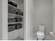 Convenient powder room featuring storage shelves, and toilet at 1620 Hasentree Villa Ln, Wake Forest, NC 27587