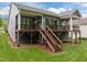 Back of house featuring stairs leading to an expansive deck and green yard at 1620 Hasentree Villa Ln, Wake Forest, NC 27587
