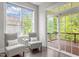 Bright sitting room with two chairs and a view to the outdoor deck with wood floor at 1620 Hasentree Villa Ln, Wake Forest, NC 27587