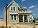 Charming two-story home featuring vertical siding, white trim and a welcoming front porch area at 1720 Bright Lantern Way, Wendell, NC 27591