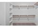 Large walk-in closet with built-in shelves and hanging rods at 1733 Birdhaven Ln # 2217, Wendell, NC 27591