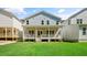 Large backyard featuring a covered porch, green grass, and a view of the home's rear exterior at 1733 Birdhaven Ln # 2217, Wendell, NC 27591