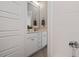 Bright bathroom featuring white cabinets, a large mirror, and modern fixtures at 1733 Birdhaven Ln # 2217, Wendell, NC 27591