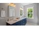 Elegant bathroom featuring double vanity, modern lighting, and a window with a serene view at 1733 Birdhaven Ln # 2217, Wendell, NC 27591