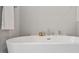 Close-up view of a soaking tub with modern fixtures and a clean, minimalist design at 1733 Birdhaven Ln # 2217, Wendell, NC 27591