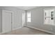 Grey walled bedroom featuring two entry doors, carpet flooring and a double-hung window at 1733 Birdhaven Ln # 2217, Wendell, NC 27591