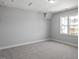 Spacious bedroom with neutral carpet, grey walls, and natural light from the windows at 1733 Birdhaven Ln # 2217, Wendell, NC 27591