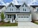 Charming two-story home with a front porch, a two-car garage, and a well-manicured lawn in a residential neighborhood at 1733 Birdhaven Ln, Wendell, NC 27591