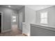 Upstairs hallway featuring carpeted floors, natural light, and easy access to all bedrooms at 1733 Birdhaven Ln # 2217, Wendell, NC 27591