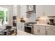 Modern kitchen with stainless steel appliances, white cabinets, and gas range at 1733 Birdhaven Ln # 2217, Wendell, NC 27591