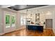 Stylish kitchen features hardwood floors, white cabinetry, stainless appliances, and a blue island with seating at 1733 Birdhaven Ln # 2217, Wendell, NC 27591