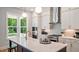 Bright kitchen featuring white cabinets, stainless steel appliances, and a large center island with a sink at 1733 Birdhaven Ln # 2217, Wendell, NC 27591
