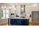 Modern kitchen featuring white cabinets, granite countertops, stainless appliances, and a blue island with bar seating at 1733 Birdhaven Ln # 2217, Wendell, NC 27591