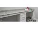Functional laundry area with granite countertops, ample storage, and space for a pet bed, offering convenience at 1733 Birdhaven Ln # 2217, Wendell, NC 27591