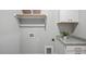 Bright laundry room with upper cabinets, utility sink, and granite countertops for efficient cleaning and storage at 1733 Birdhaven Ln # 2217, Wendell, NC 27591