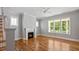 Spacious living room with hardwood floors, fireplace, and large windows providing natural light and a cozy ambiance at 1733 Birdhaven Ln # 2217, Wendell, NC 27591