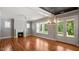 Bright living room featuring a fireplace, hardwood floors, and French doors leading to an outdoor patio at 1733 Birdhaven Ln # 2217, Wendell, NC 27591