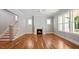 Bright living room with hardwood floors, a fireplace, and large windows, creating a comfortable gathering space at 1733 Birdhaven Ln # 2217, Wendell, NC 27591