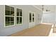 Inviting porch with wood floors, large windows, a ceiling fan, and views of the yard at 1733 Birdhaven Ln # 2217, Wendell, NC 27591