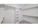 Organized walk-in closet with built-in shelving and rods for ample storage space at 1733 Birdhaven Ln # 2217, Wendell, NC 27591