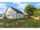 Spacious backyard featuring a well-maintained lawn and covered patio perfect for outdoor enjoyment at 186 N Ashe Ave, Dunn, NC 28334