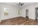 Spacious bedroom with wood-look floors, ceiling fan, recessed lighting and two bright windows at 186 N Ashe Ave, Dunn, NC 28334
