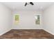 Bedroom featuring two bright windows, a ceiling fan, recessed lighting, and attractive wood-look flooring at 186 N Ashe Ave, Dunn, NC 28334
