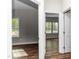 View of two bedrooms featuring hardwood floors and bright windows at 186 N Ashe Ave, Dunn, NC 28334