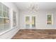 Bright dining area featuring wood-look floors, white trim, and a modern starburst lighting fixture at 186 N Ashe Ave, Dunn, NC 28334