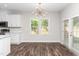 Eat-in dining area with modern chandelier, table seating, wood flooring and natural light at 186 N Ashe Ave, Dunn, NC 28334