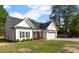 Charming home featuring a black roof, white siding, an attached garage and a lovely lawn at 186 N Ashe Ave, Dunn, NC 28334