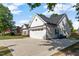 Beautiful home showcasing white siding, a black roof, an attached garage and a wide driveway at 186 N Ashe Ave, Dunn, NC 28334