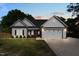 Beautiful single-story home with a gray exterior, well-manicured lawn, and attached two-car garage at 186 N Ashe Ave, Dunn, NC 28334