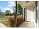 Charming front porch with vibrant red flowers and decorative black support beams, adding curb appeal at 186 N Ashe Ave, Dunn, NC 28334