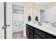 Bathroom features double vanity, framed mirror, and shower/tub combo with a floral curtain at 2008 Campana Dr, Raleigh, NC 27603