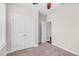 This bedroom has neutral walls, carpet flooring, a ceiling fan and a double-door closet for plenty of storage at 2008 Campana Dr, Raleigh, NC 27603