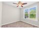 Bright bedroom with neutral walls, carpet flooring, and a window offering natural light and views of the outdoors at 2008 Campana Dr, Raleigh, NC 27603